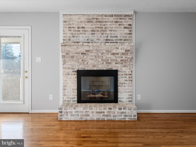 room details with hardwood / wood-style floors and a fireplace