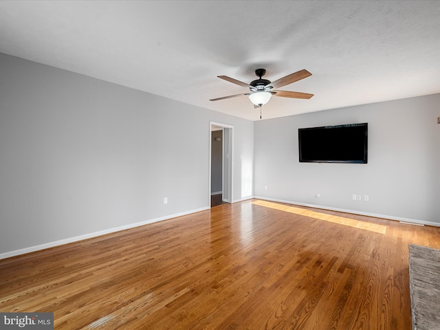 spare room with light hardwood / wood-style flooring and ceiling fan