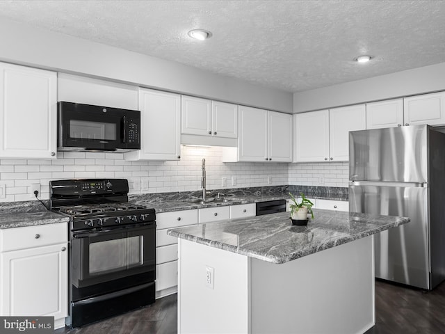 kitchen featuring white cabinets, a kitchen island, and black appliances