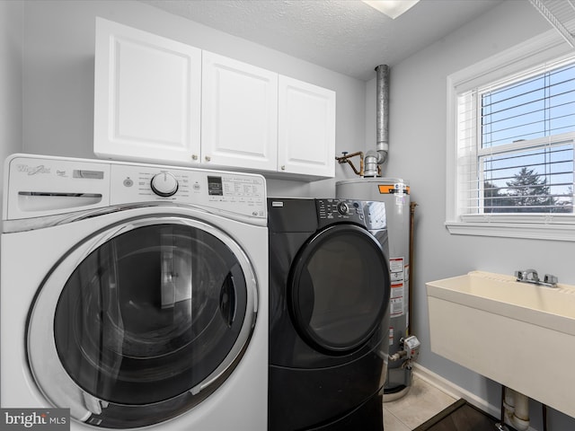 washroom with cabinets, a textured ceiling, sink, water heater, and separate washer and dryer