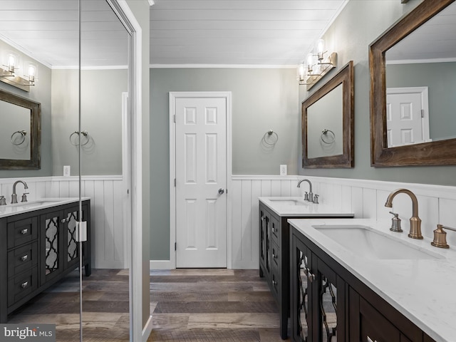 bathroom featuring crown molding, vanity, and wood-type flooring