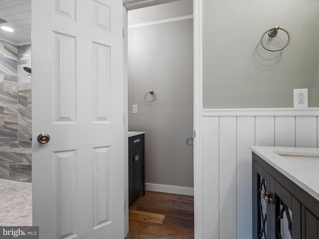 bathroom with a shower, crown molding, vanity, and hardwood / wood-style flooring