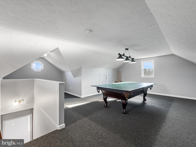 recreation room with dark colored carpet, a textured ceiling, vaulted ceiling, and pool table