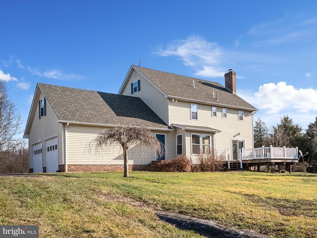 rear view of house with a yard and a wooden deck