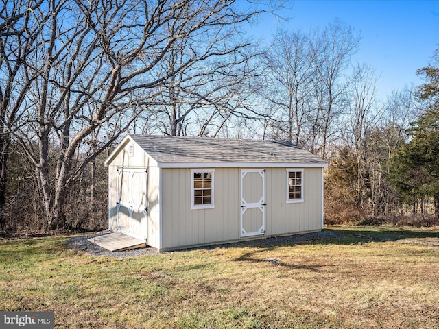 view of outbuilding with a lawn