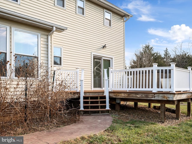 rear view of property featuring a wooden deck