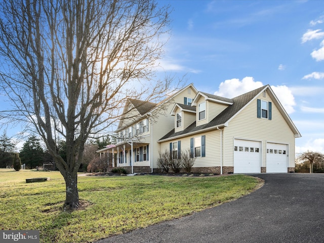 cape cod home featuring a garage and a front yard