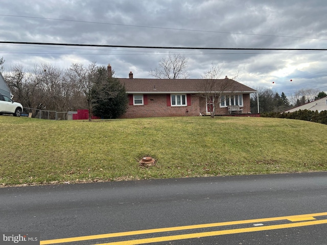 ranch-style home with a front lawn