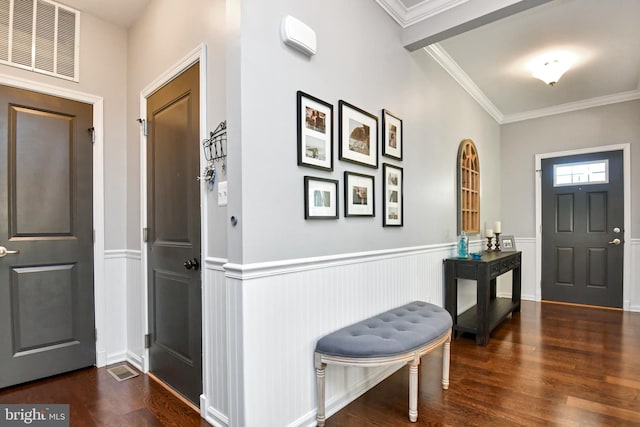 entrance foyer with dark hardwood / wood-style floors and ornamental molding