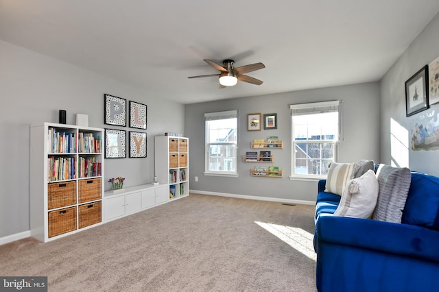 sitting room with carpet flooring and ceiling fan