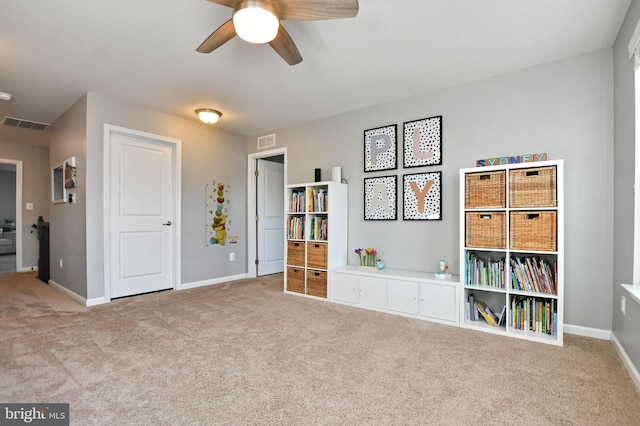 misc room featuring light carpet and ceiling fan