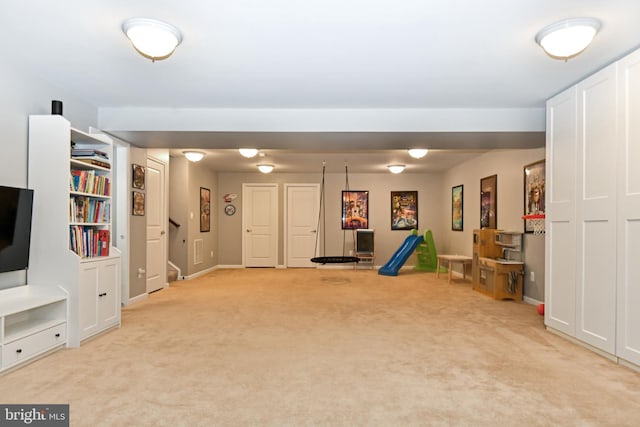 game room featuring light carpet