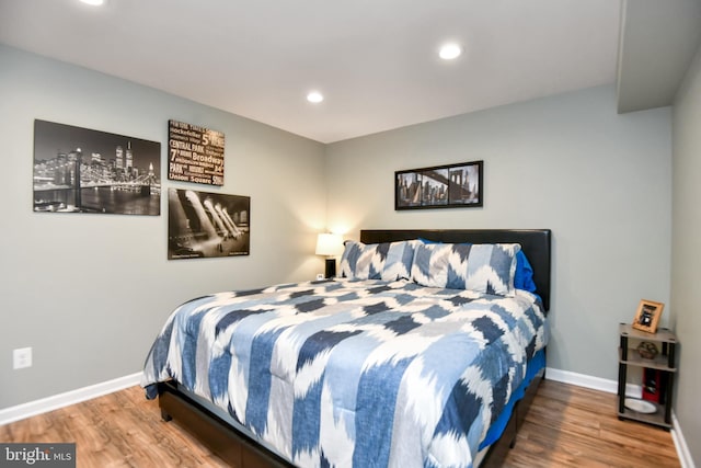 bedroom with hardwood / wood-style floors