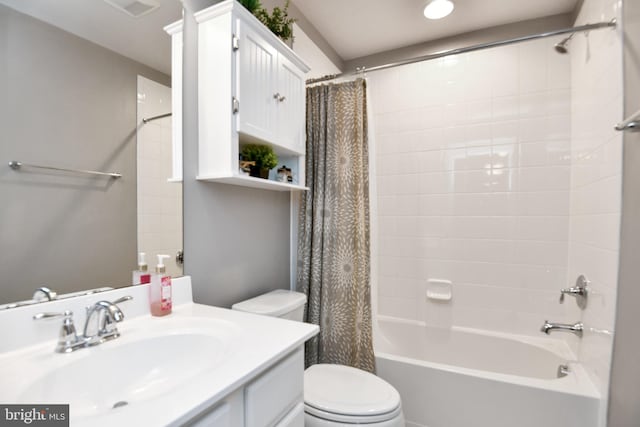 full bathroom featuring vanity, shower / tub combo, and toilet