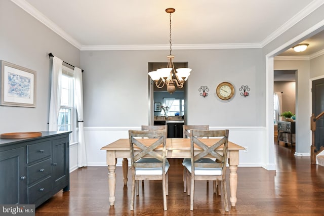 dining space with a chandelier, dark wood-type flooring, and crown molding