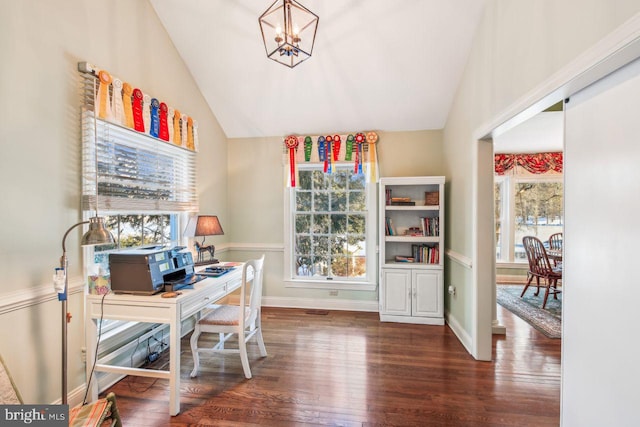 office area with a notable chandelier, a healthy amount of sunlight, wood finished floors, and vaulted ceiling