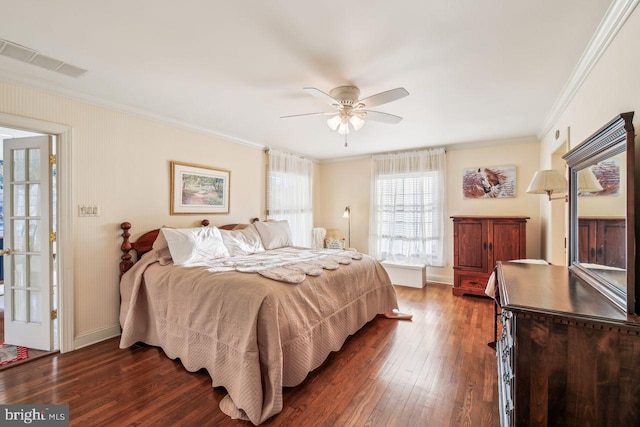 bedroom with baseboards, visible vents, dark wood finished floors, ceiling fan, and ornamental molding