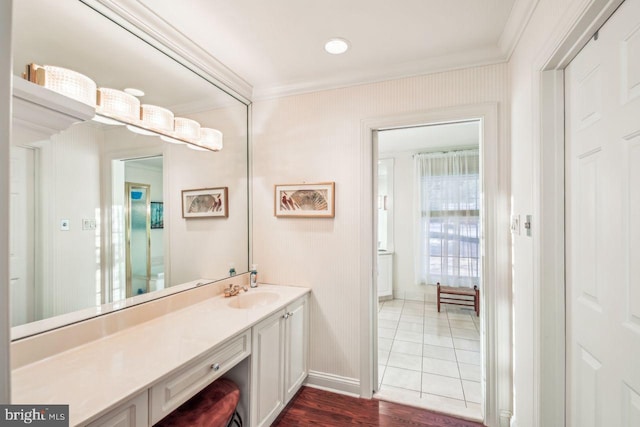 bathroom with tile patterned flooring, vanity, and crown molding