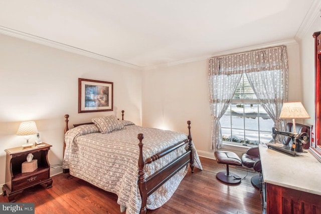 bedroom with dark wood finished floors, crown molding, and baseboards