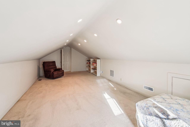 bonus room featuring light colored carpet and vaulted ceiling