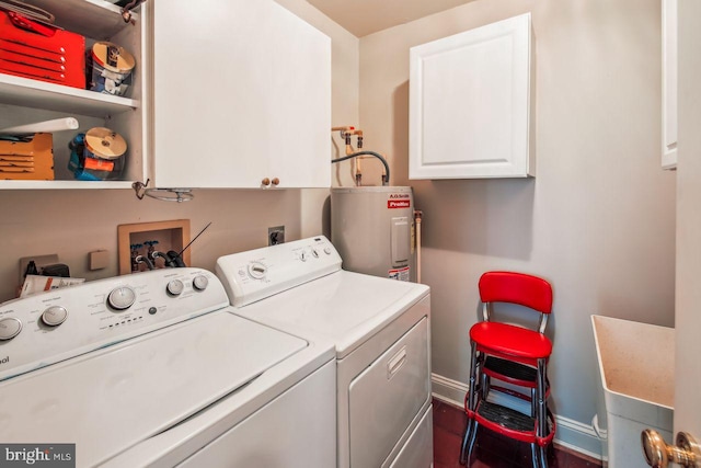 laundry room featuring cabinet space, washing machine and dryer, electric water heater, and baseboards