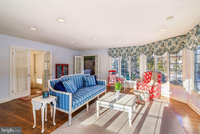 living room featuring recessed lighting, baseboards, and wood finished floors