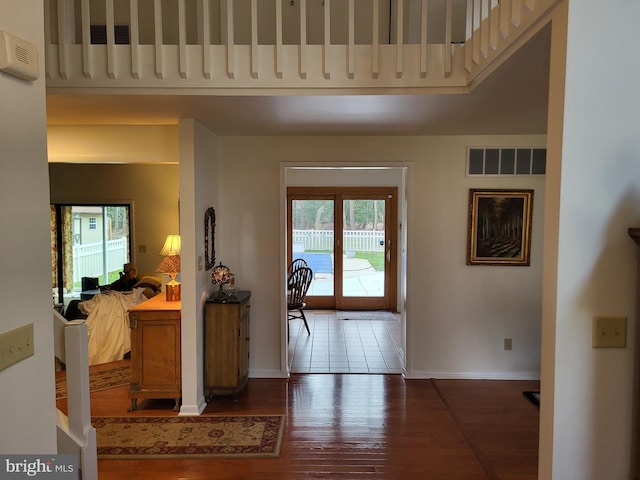 foyer featuring dark wood-type flooring and a wealth of natural light