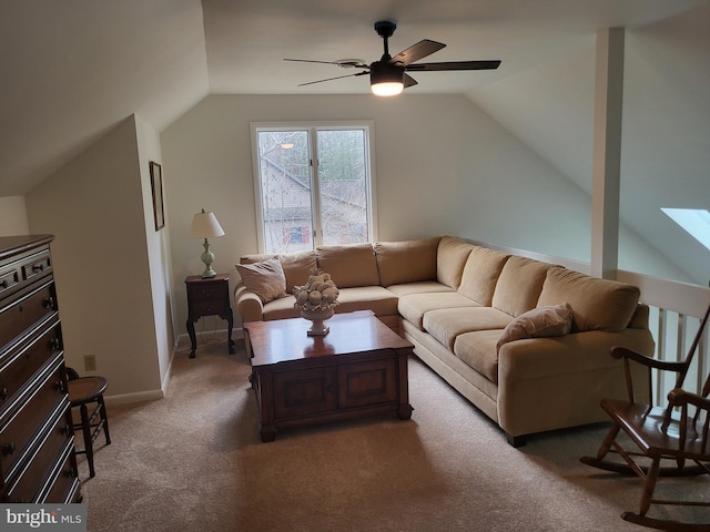 carpeted living room with ceiling fan and vaulted ceiling