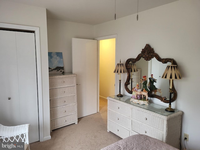 bedroom with light carpet and a closet