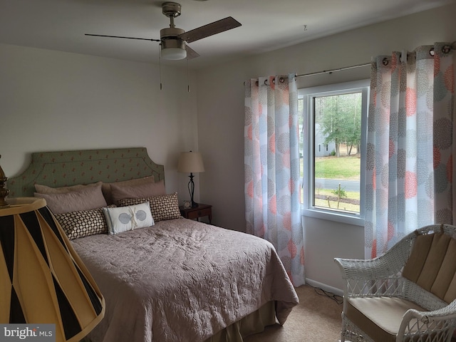 carpeted bedroom with multiple windows and ceiling fan