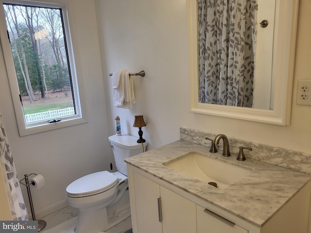 bathroom featuring vanity and toilet