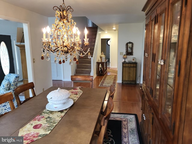 dining area with a notable chandelier and dark hardwood / wood-style floors