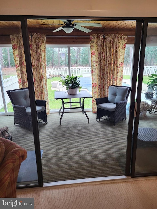 interior space with ceiling fan