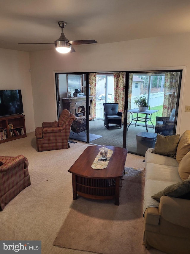 carpeted living room featuring ceiling fan