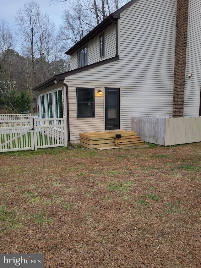 rear view of house with a wooden deck