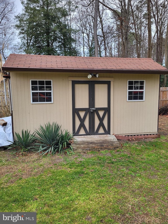 view of outbuilding with a lawn