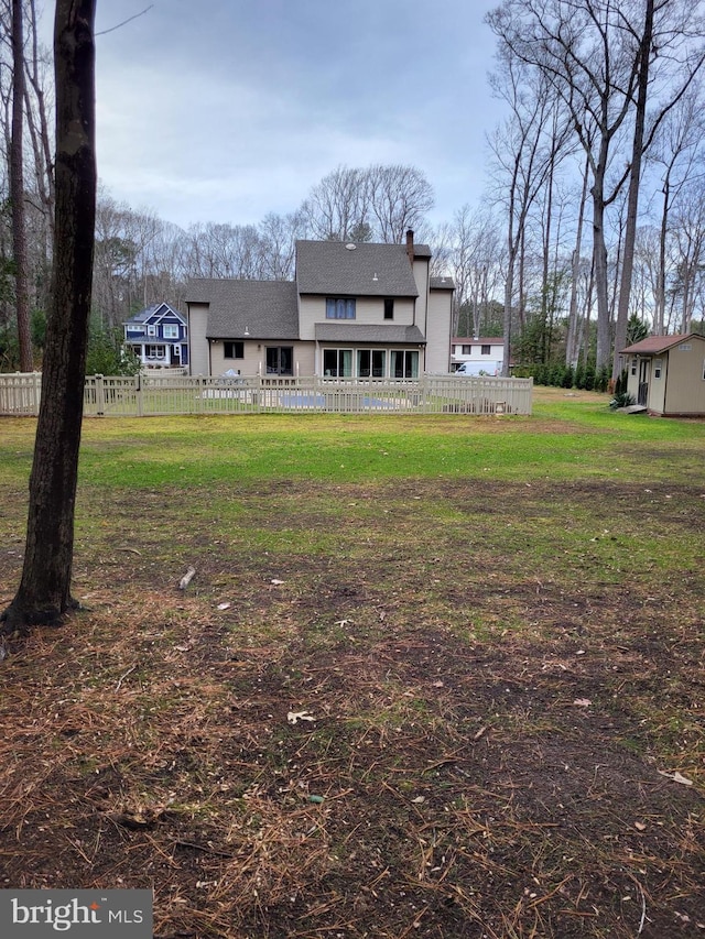 rear view of house with a lawn