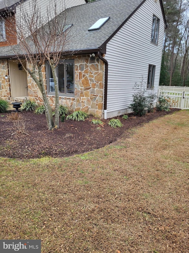 view of side of home featuring a lawn