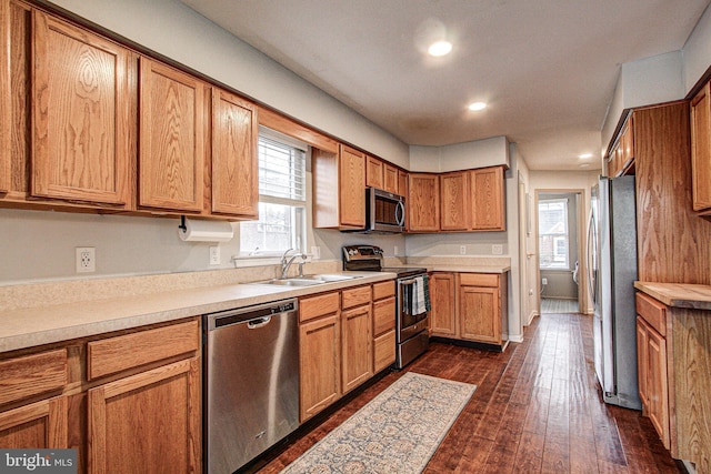 kitchen with sink, appliances with stainless steel finishes, and dark wood-type flooring