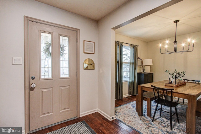 entryway featuring dark hardwood / wood-style flooring, plenty of natural light, and a chandelier