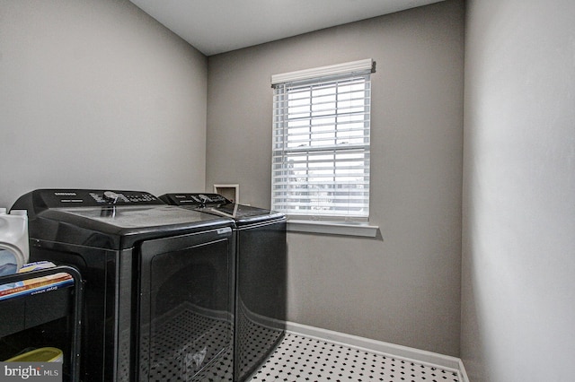 clothes washing area with washer and clothes dryer