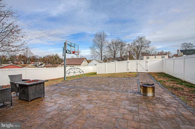 view of patio / terrace with basketball court and a fire pit