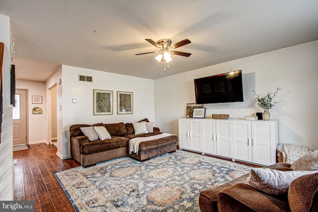 living room with ceiling fan and dark wood-type flooring