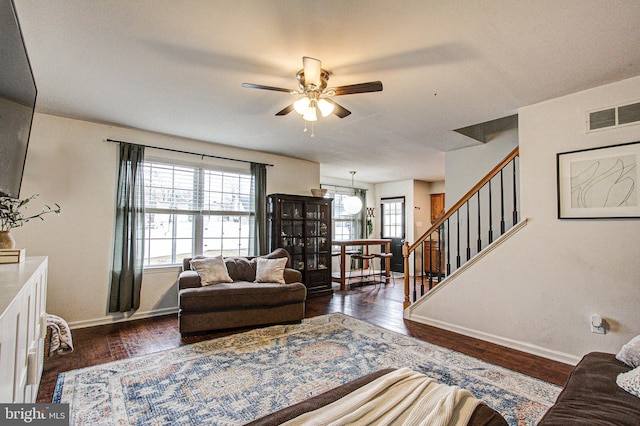 living room with ceiling fan and dark wood-type flooring