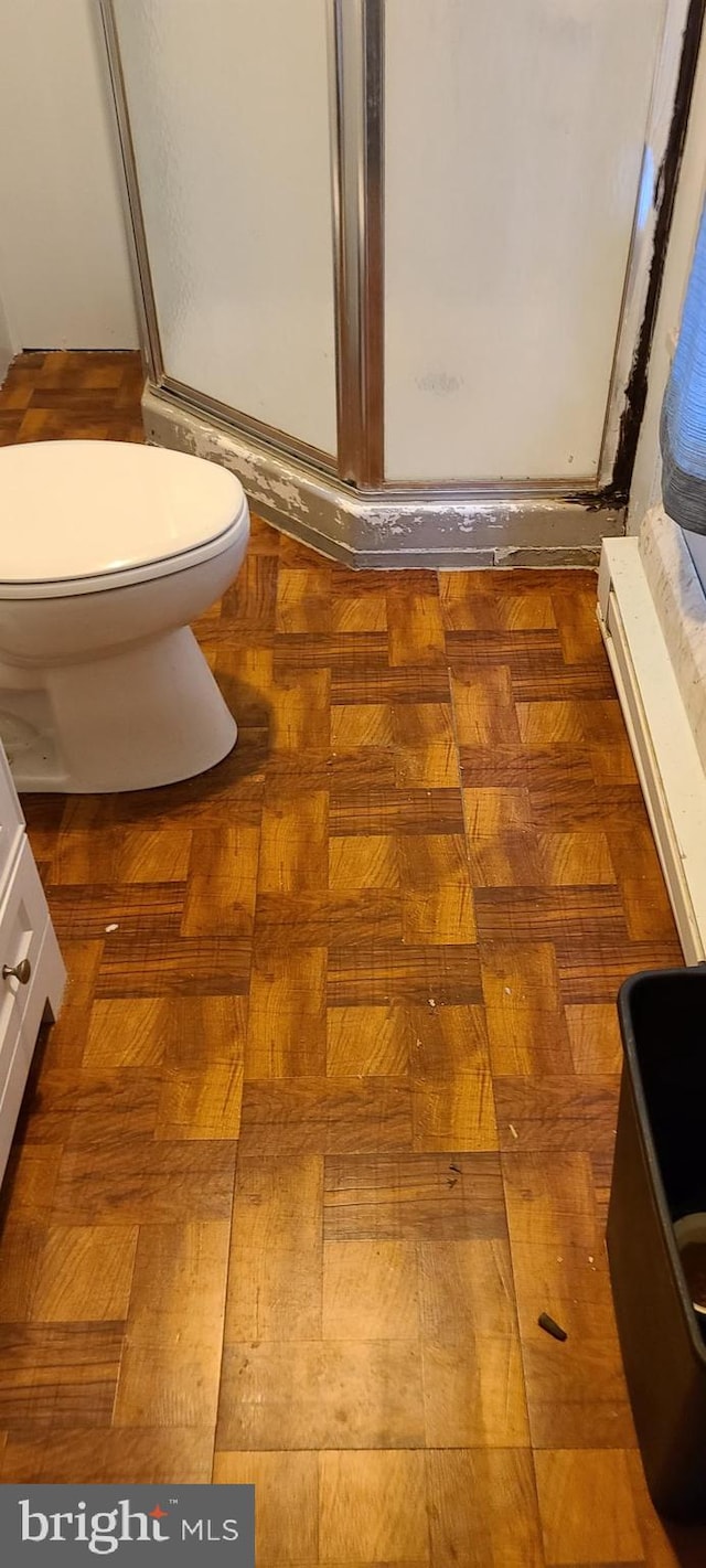 room details featuring a stall shower and toilet