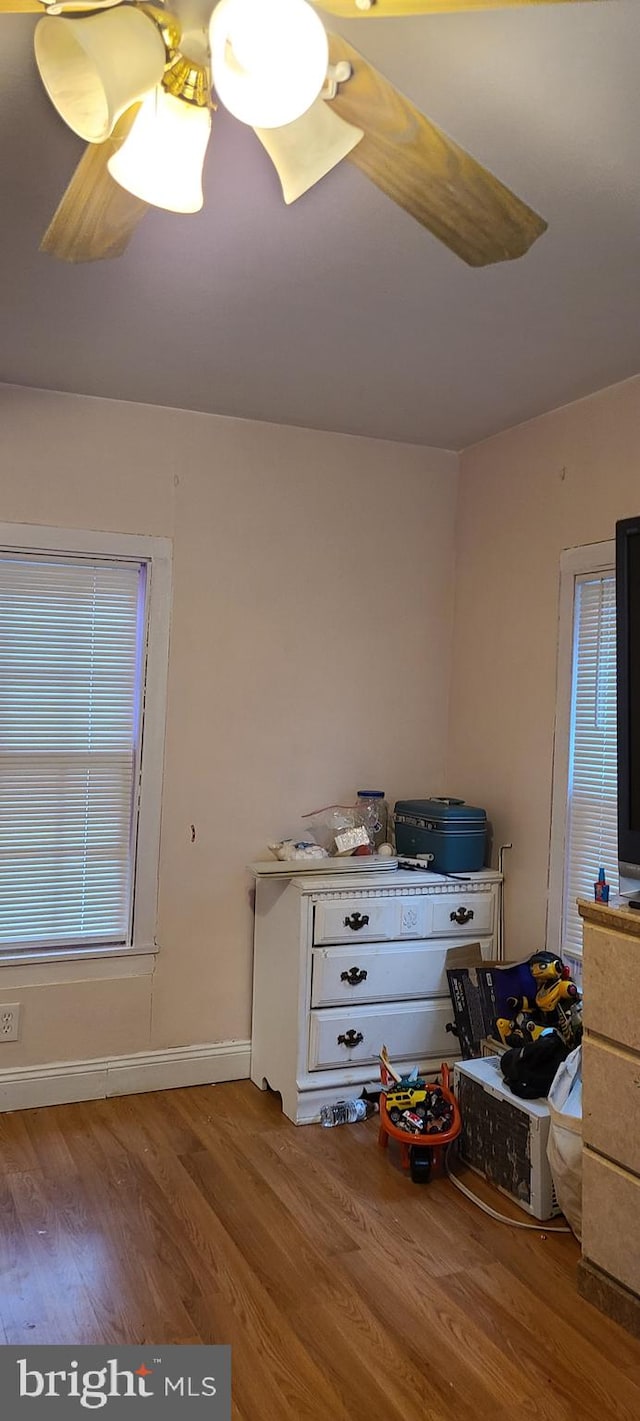 interior space featuring baseboards and wood finished floors