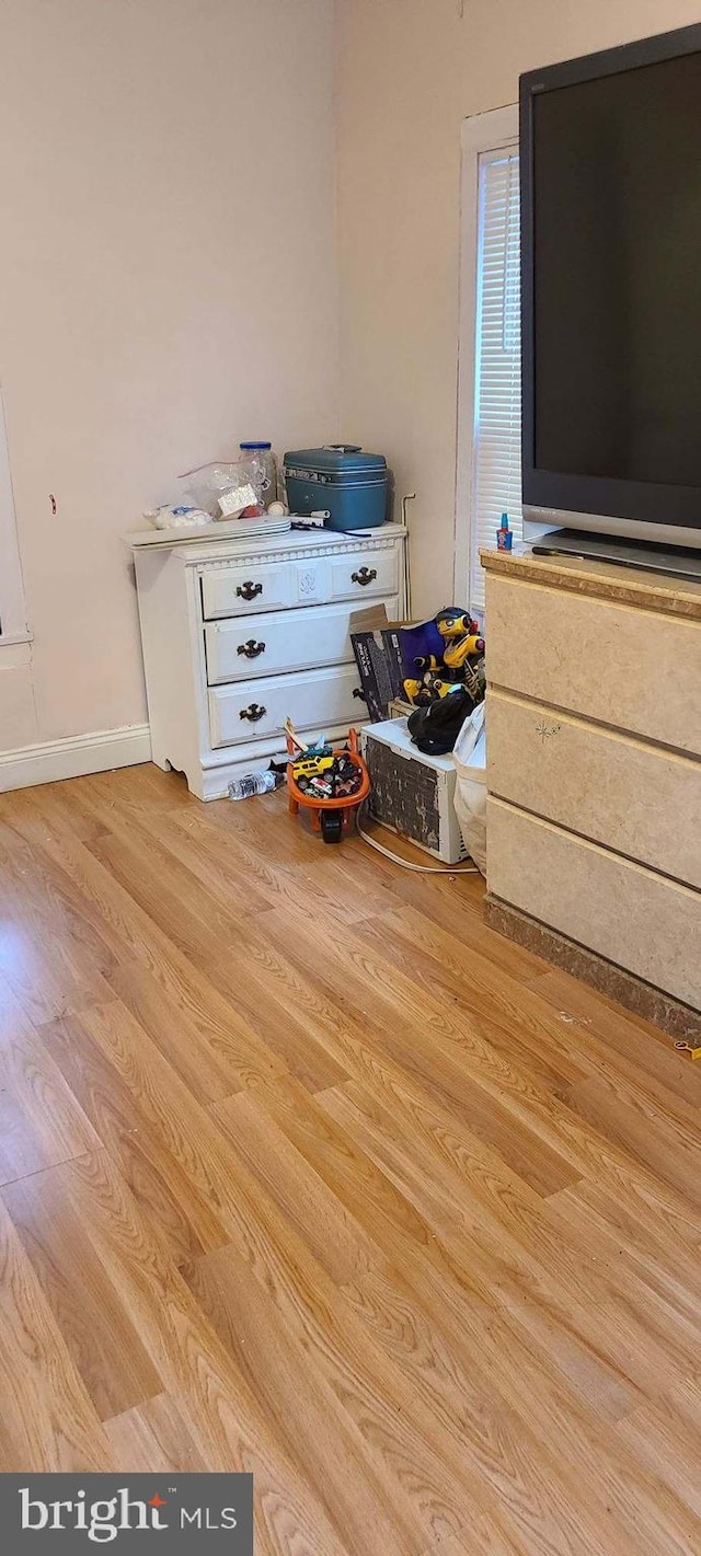 interior space with wood finished floors and baseboards