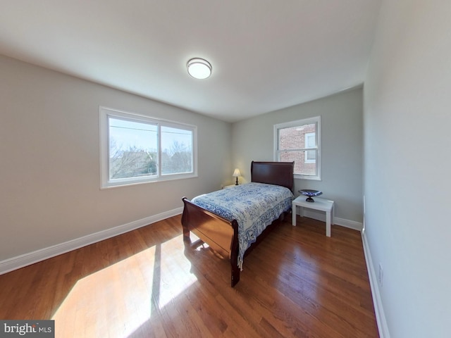 bedroom featuring baseboards and wood finished floors