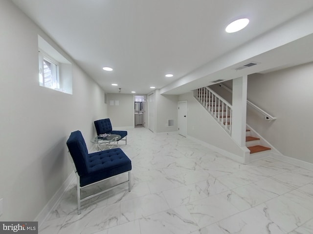 sitting room featuring stairway, marble finish floor, visible vents, and baseboards