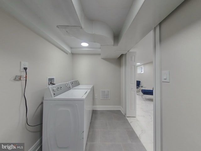 washroom featuring visible vents, independent washer and dryer, marble finish floor, and baseboards